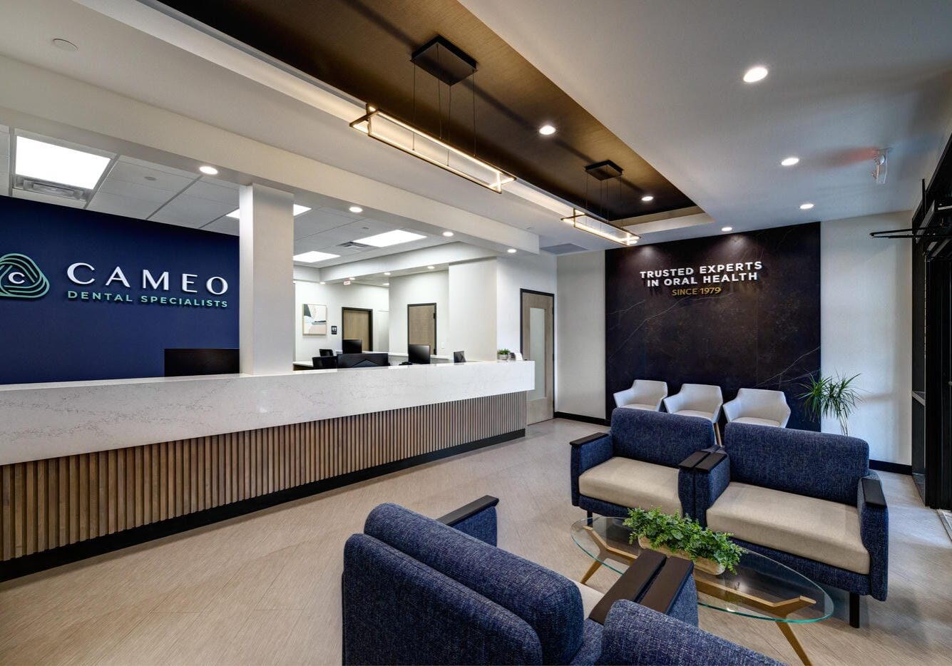 Dental Reception desk with illuminated brand logo wall — Cameo Dental Specialists, LaGrange